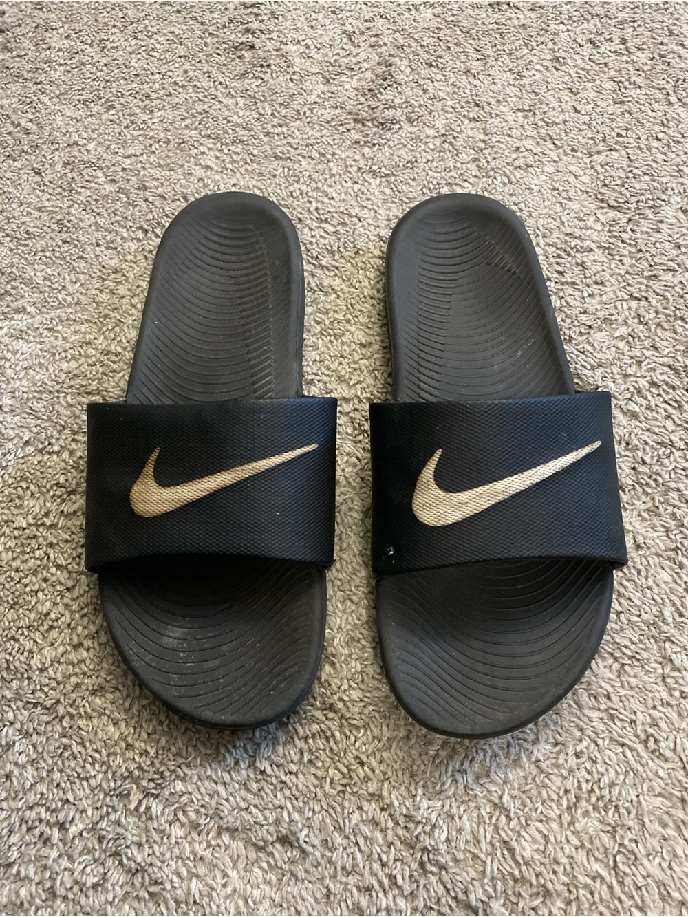 Nike Black Slides with Gold Swoosh Accent